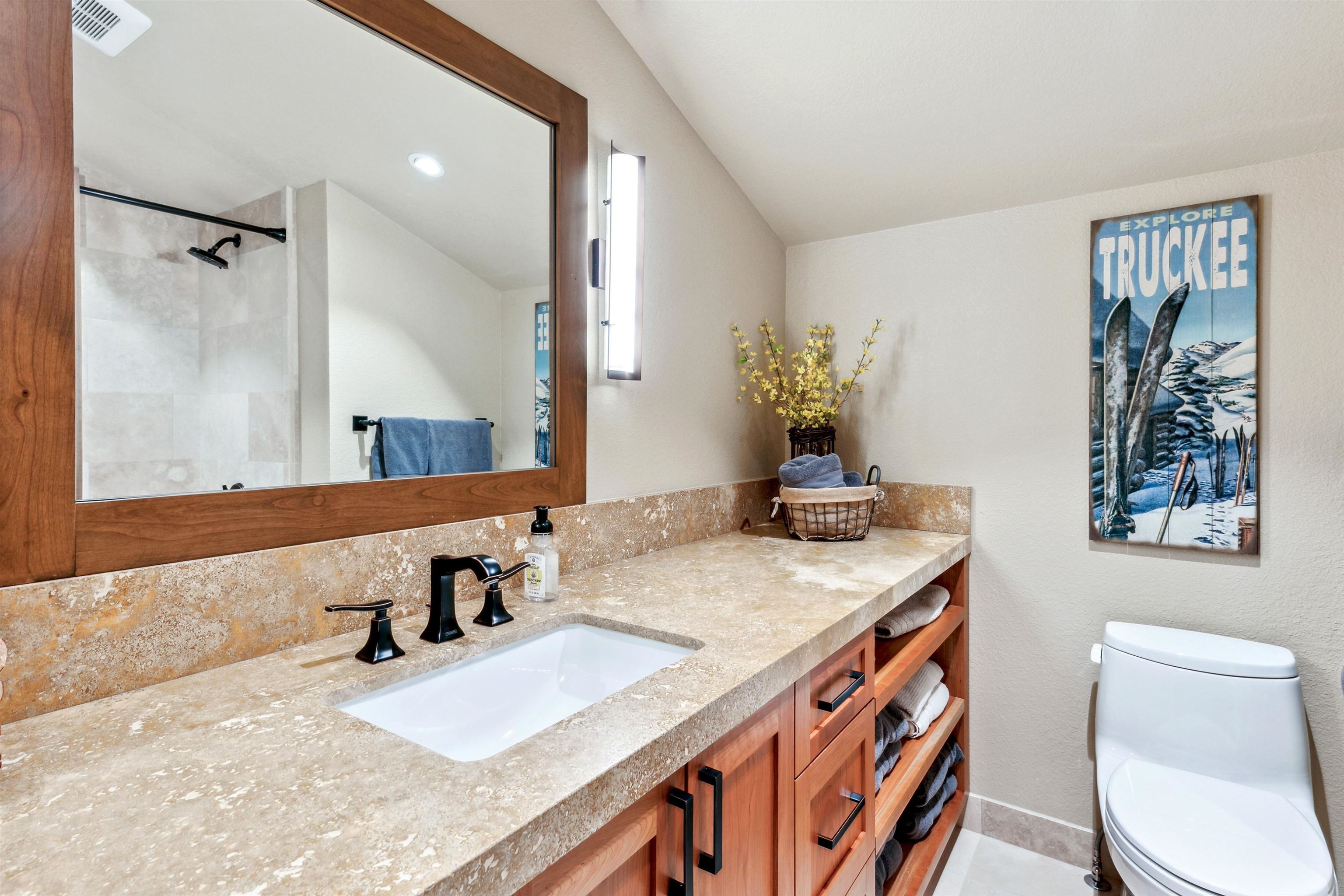 14204 Ski View Loop Truckee, CA 96161 - Photo 22 of 28 a bathroom with a granite countertop sink a toilet a mirror and shower