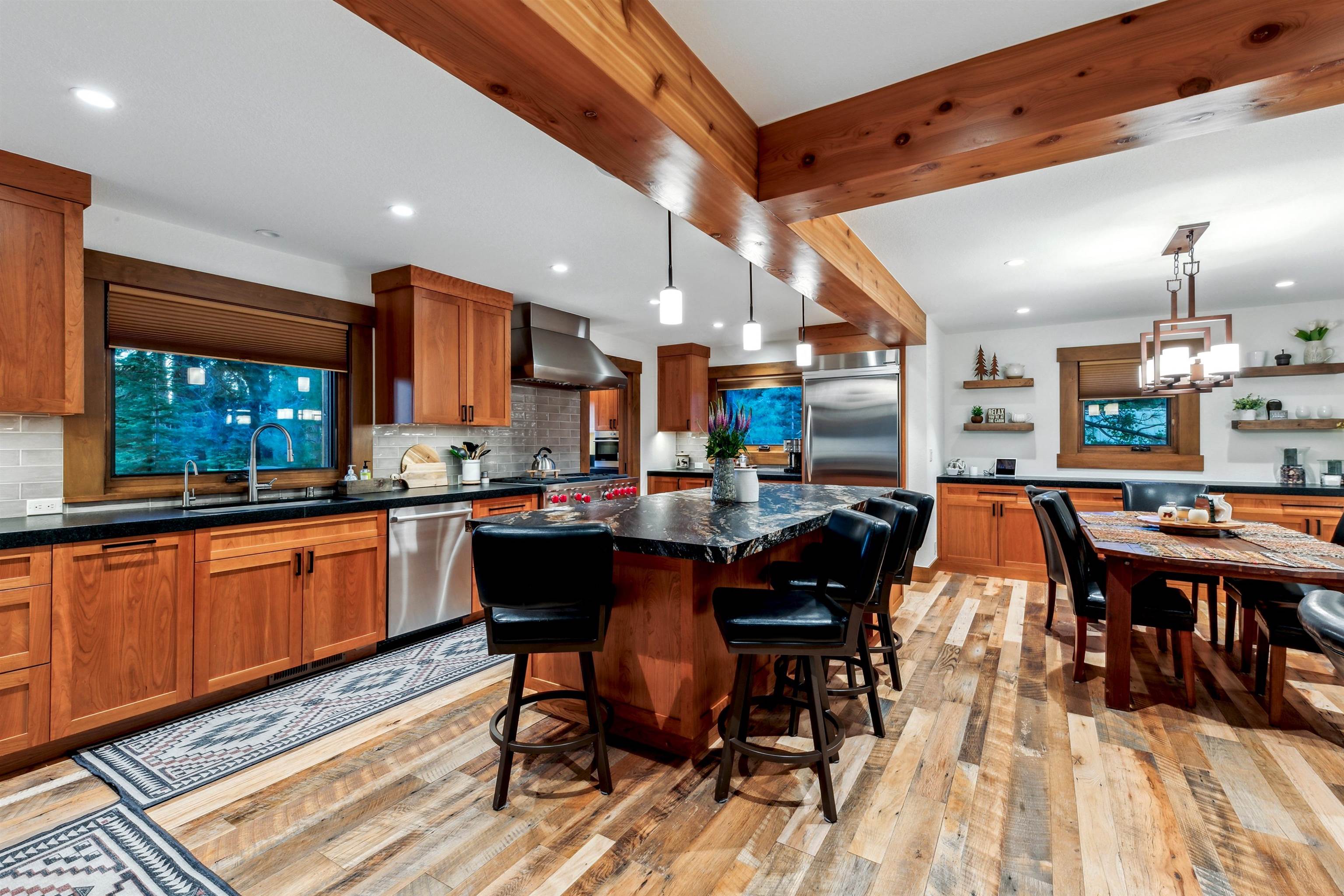 14204 Ski View Loop Truckee, CA 96161 - Photo 9 of 28 a dining hall with stainless steel appliances kitchen island granite countertop wooden floor a dining table and chairs