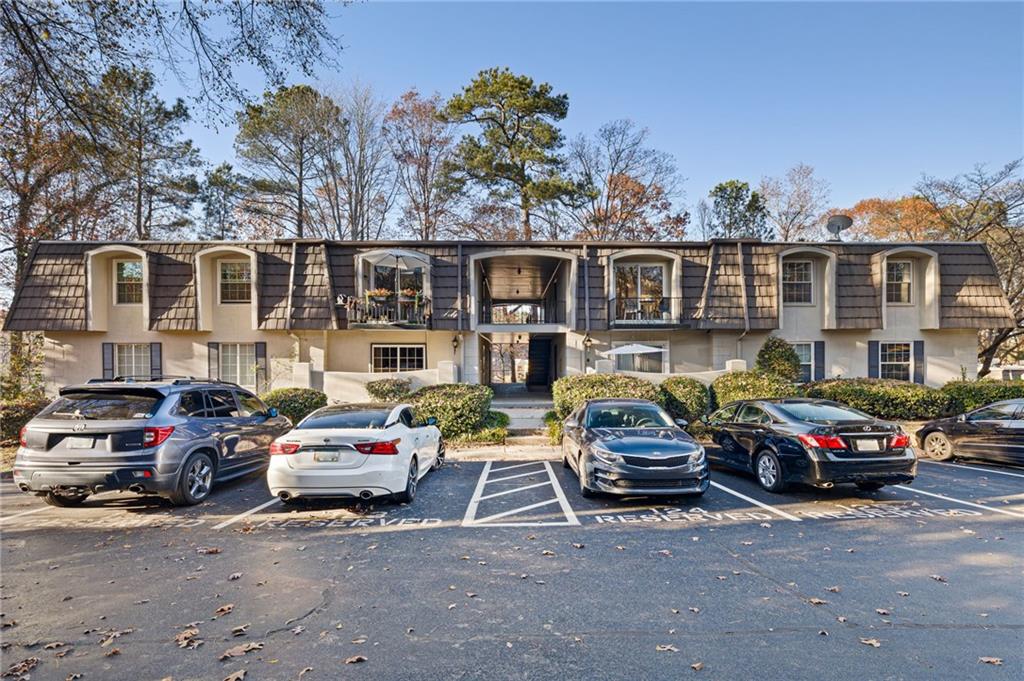 725 Dalrymple Road, Unit 8D Sandy Springs, GA 30328 - Photo 1 of 1 a front view of a house with cars parked