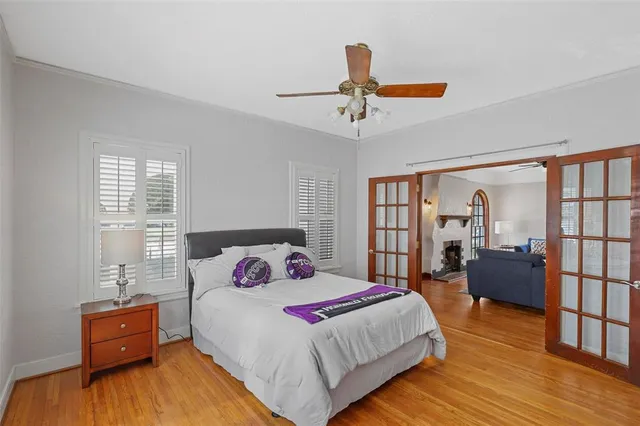 a bedroom with a bed and wooden floor