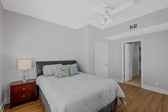 a bedroom with a bed and a night stand