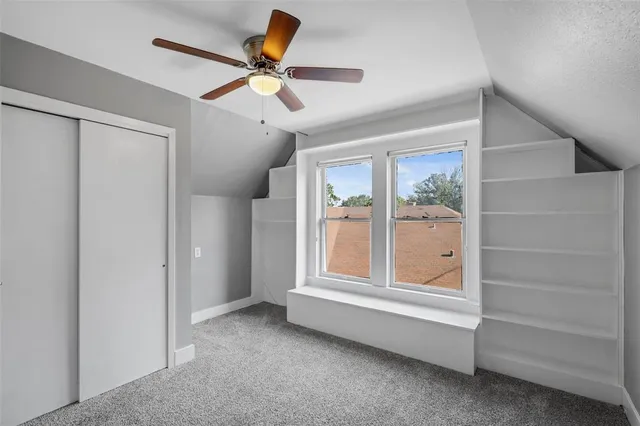 a view of room with ceiling fan and window
