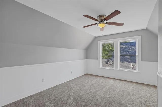 a view of a livingroom with a ceiling fan and window
