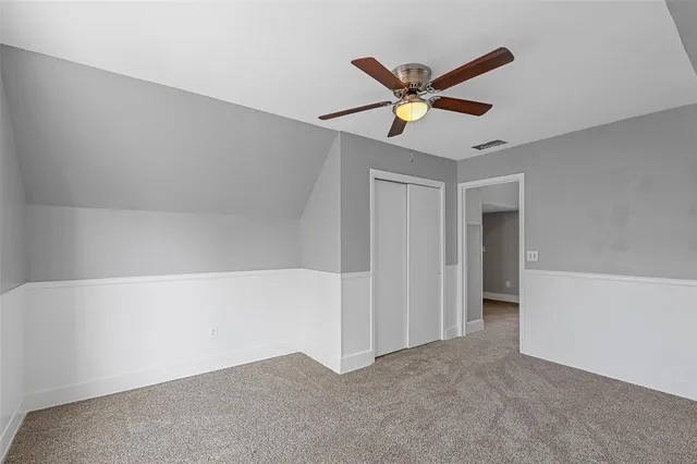 a view of a hallway with a ceiling fan