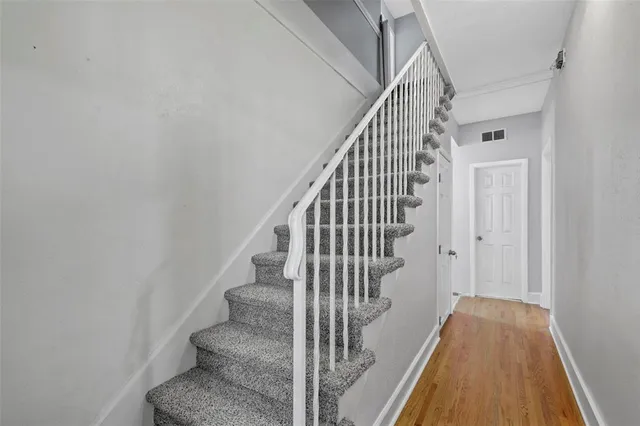 a view of entryway and hall with wooden floor