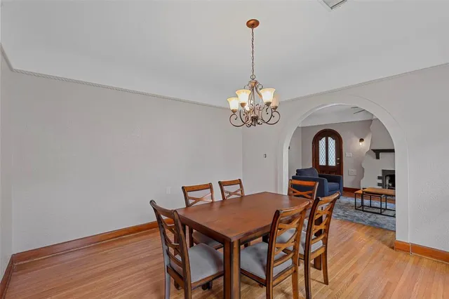 a view of a dining room with furniture wooden floor and chandelier