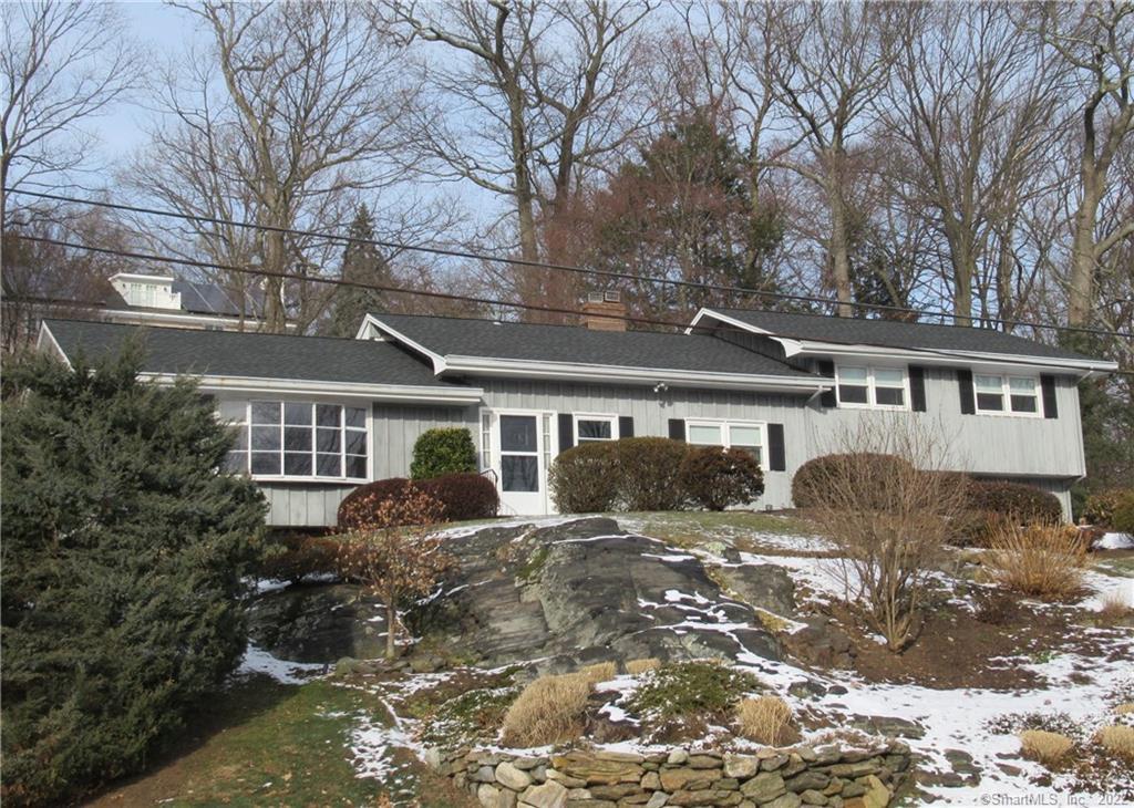 20 Random Road Fairfield, CT 06825 - Photo 1 of 1 a front view of a house with yard and trees in the background