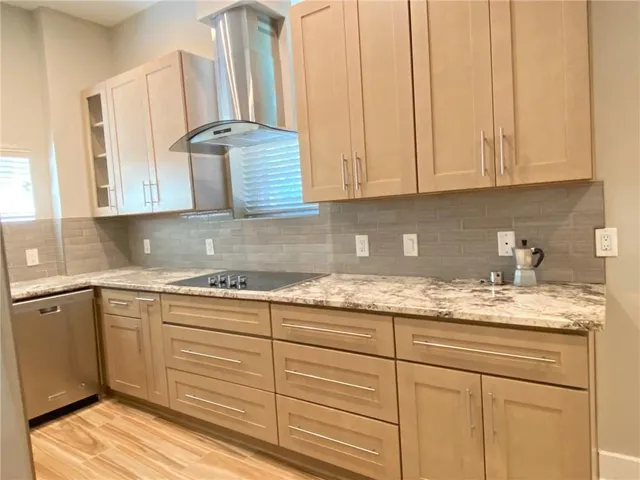 a kitchen with granite countertop white cabinets and white appliances
