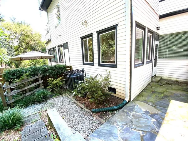 a view of a house with backyard and sitting area