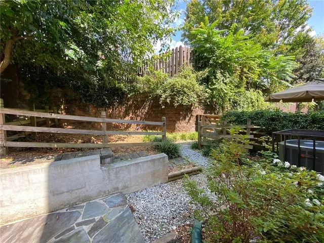 a view of backyard with seating area and trees