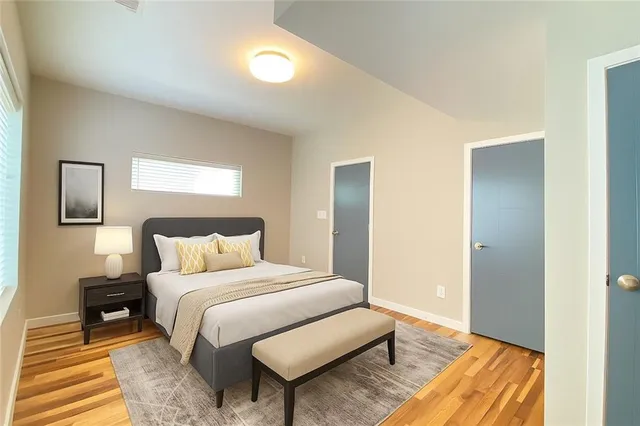 a bedroom with a bed and a mirror