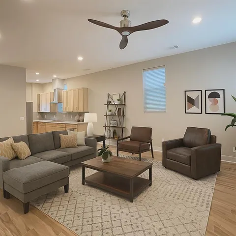 a living room with furniture and kitchen view