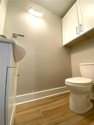a bathroom with a toilet and a mirror