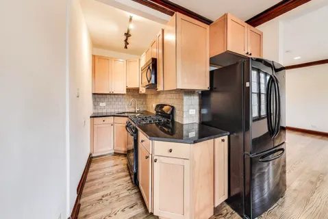 a kitchen with stainless steel appliances a refrigerator stove and sink