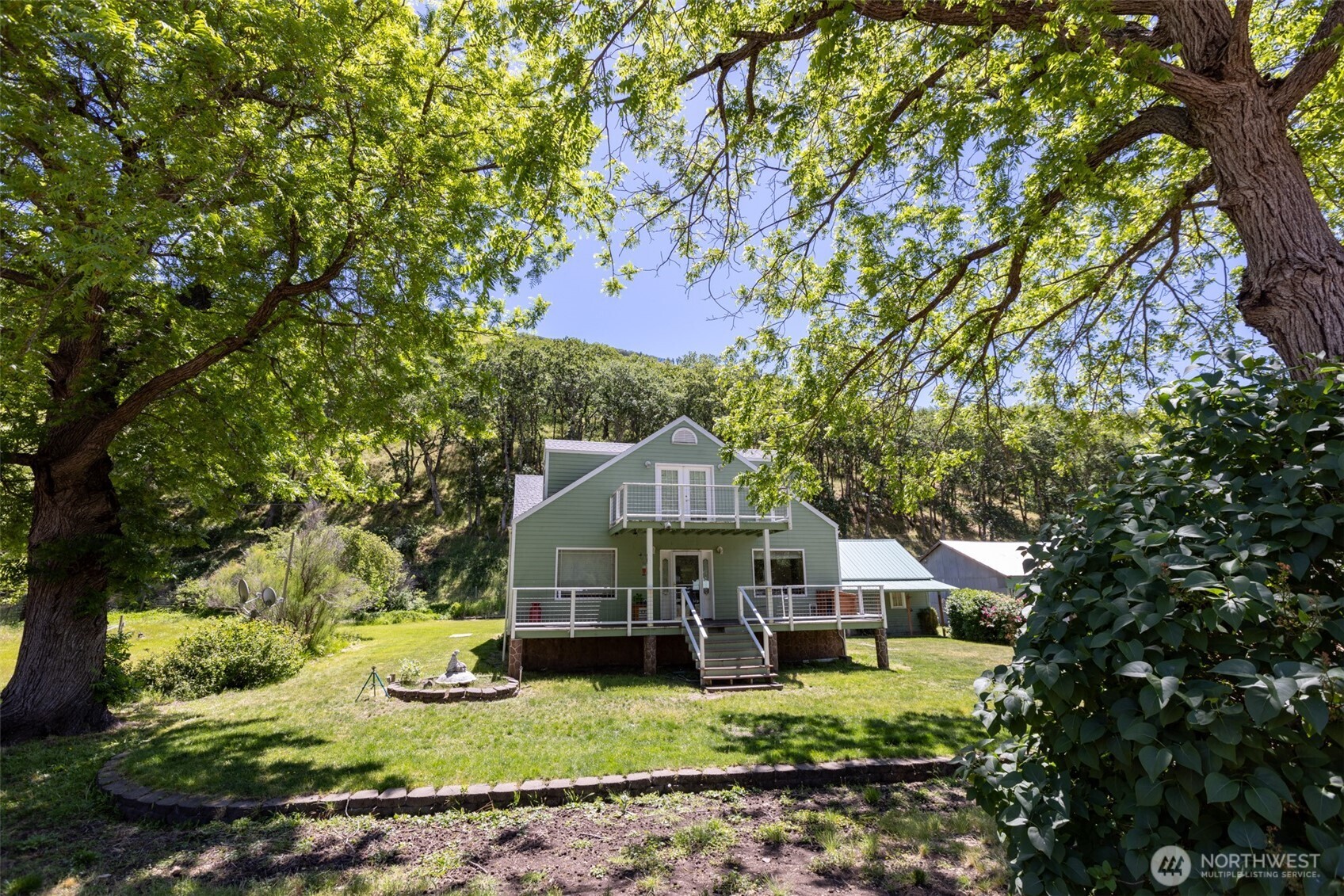 992 Highway 142 Lyle, WA 98635 - Photo 7 of 40 a front view of a house with garden