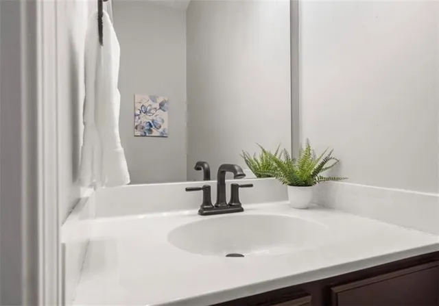 a bathroom with a sink a vanity and a tub