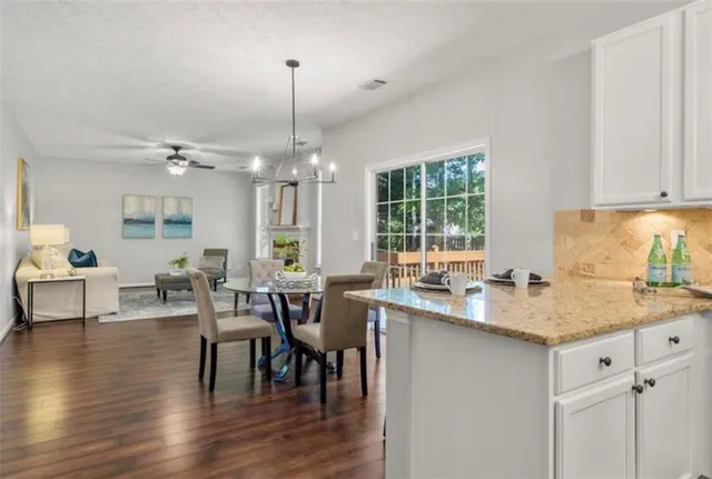 a kitchen with center island table and chairs