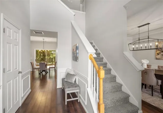 a view of entryway and dining room with wooden floor