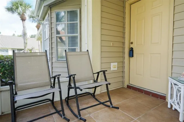 a view of a house with backyard and sitting area