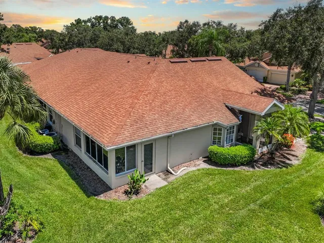 a aerial view of a house with a yard table and chairs