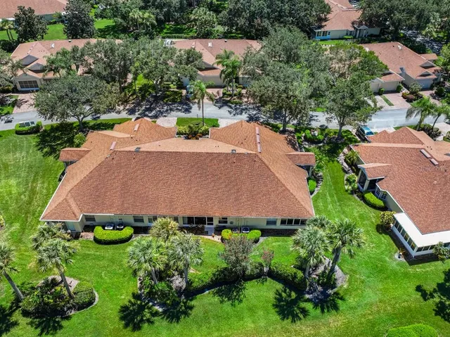 an aerial view of a house with a yard and lake view