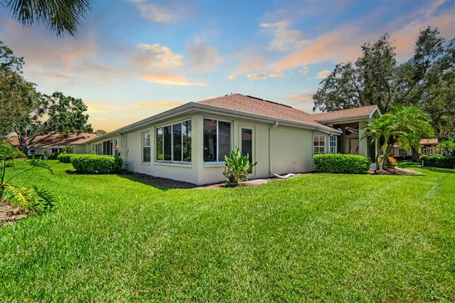 a view of a house with a backyard