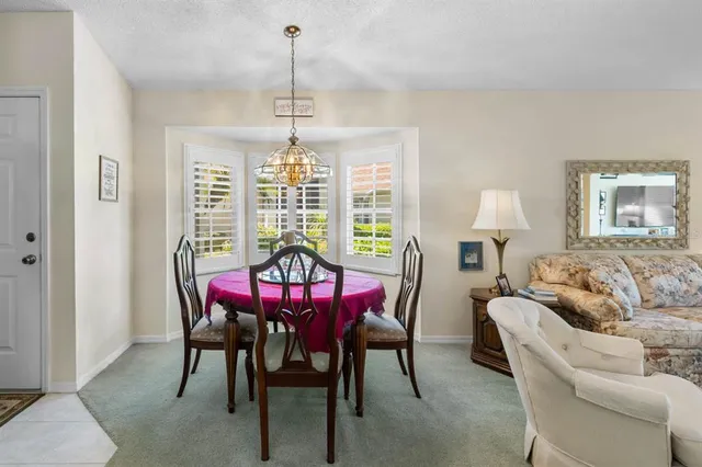 a view of a dining room with furniture window and outside view