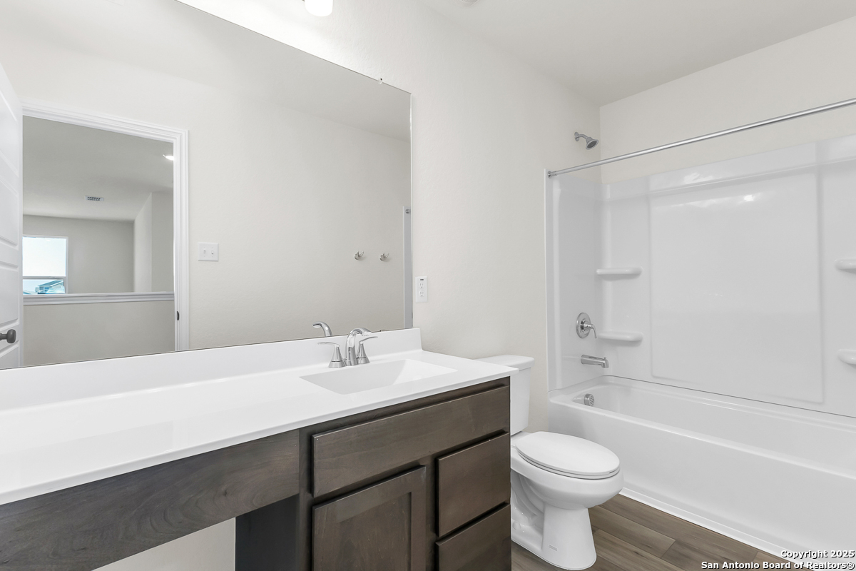 9515 Griffith Run Converse, TX 78109 - Photo 15 of 18 a bathroom with a sink a toilet a mirror and shower