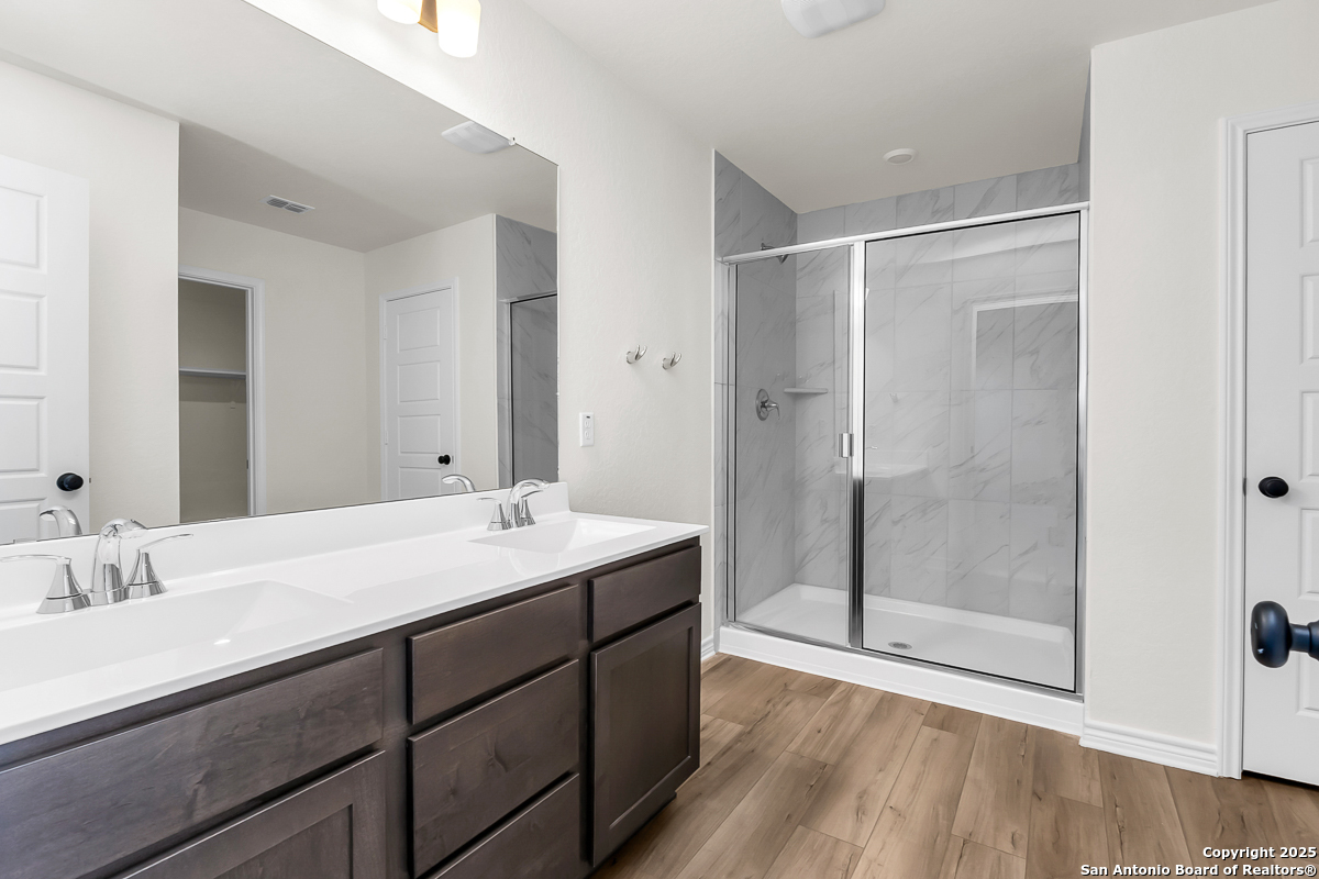 9515 Griffith Run Converse, TX 78109 - Photo 10 of 18 a bathroom with a shower sink and mirror