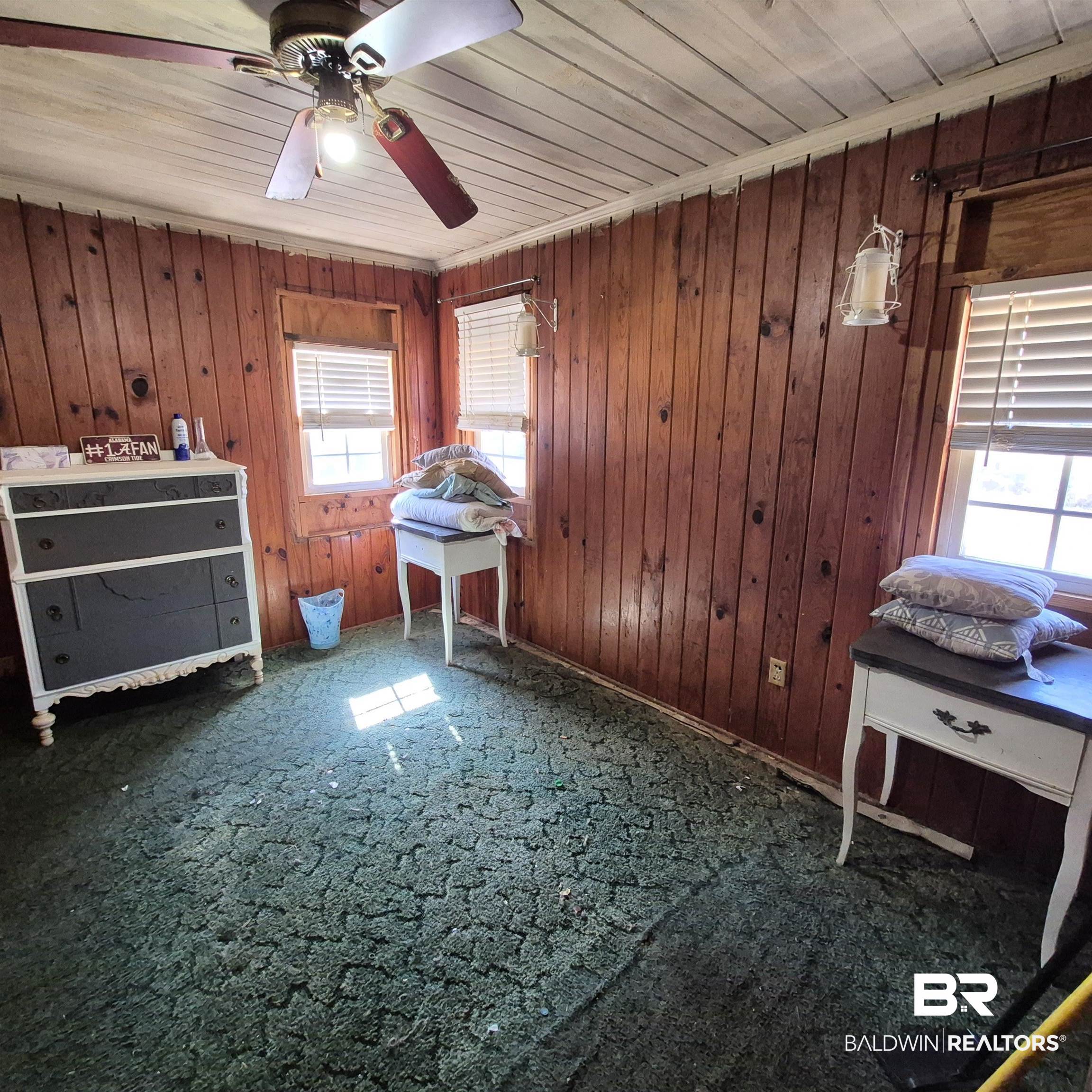 320 Bruner Avenue Evergreen, AL 36401 - Photo 7 of 15 Bedroom featuring wooden walls, a ceiling fan, wood ceiling, and carpet