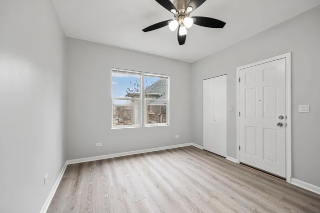 an empty room with a window and wooden floor