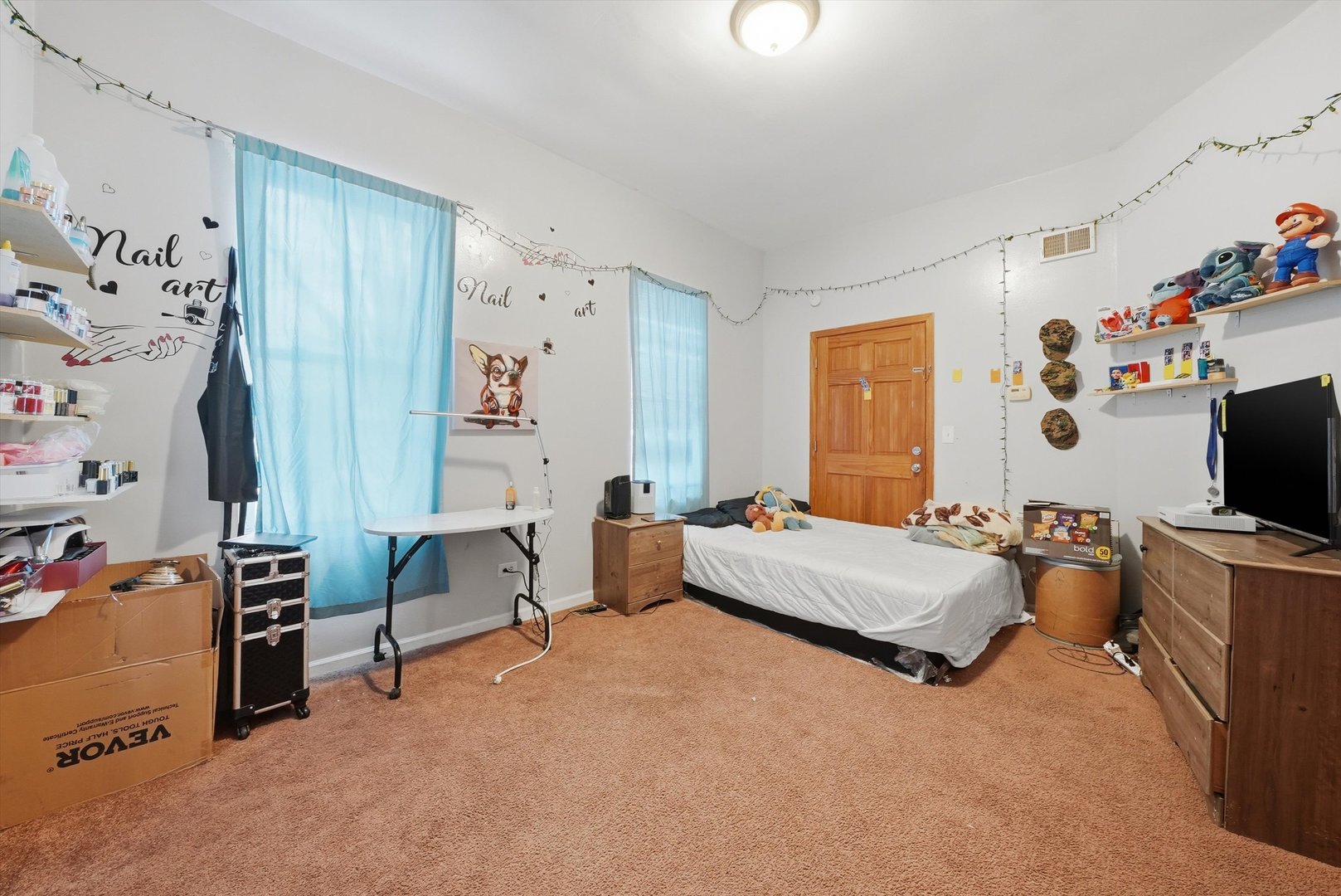 4418 West Armitage Avenue Chicago, IL 60639 - Photo 37 of 59 a bedroom with furniture and a flat screen tv