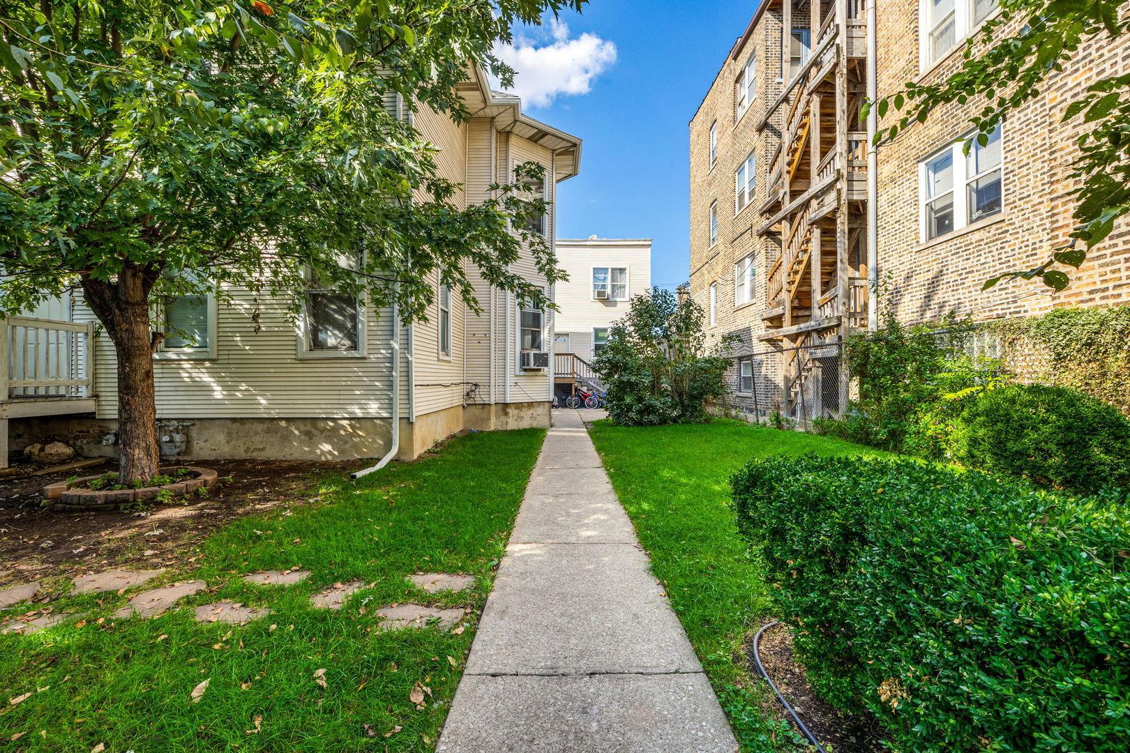 4418 West Armitage Avenue Chicago, IL 60639 - Photo 6 of 59 a view of a pathway with house on both side