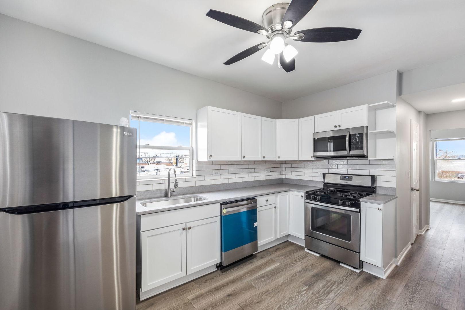 4418 West Armitage Avenue Chicago, IL 60639 - Photo 8 of 59 a kitchen with stainless steel appliances granite countertop a stove a sink and a refrigerator