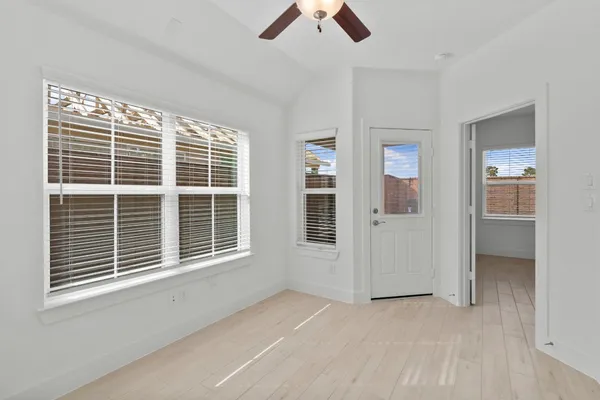 a view of empty room with ceiling fan