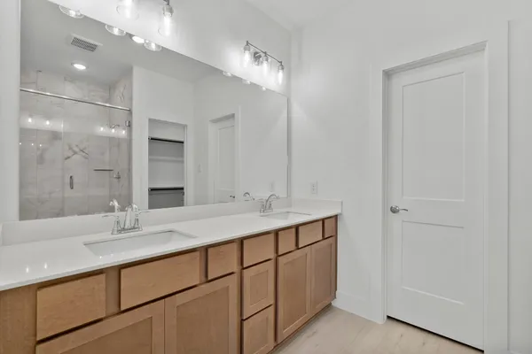 a bathroom with a double vanity sink and a mirror