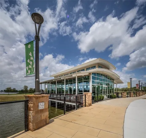 a view of a lake from a balcony with outdoor seating