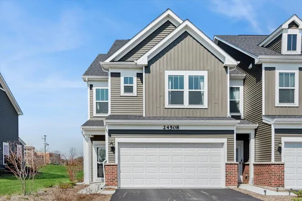 a front view of a house with a garage