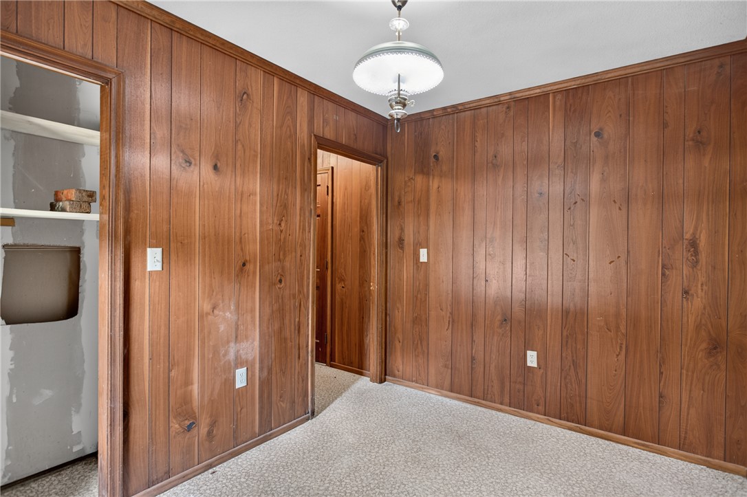 1412 Simpson Road Pendleton, SC 29670 - Photo 18 of 48 Wood paneling and patterned carpet create a cozy atmosphere in this adaptable room.