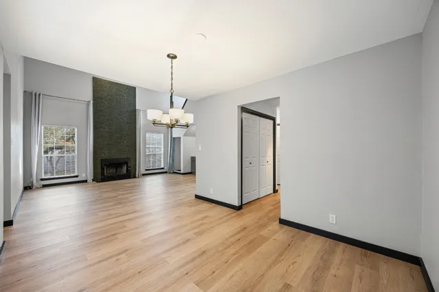 a view of a kitchen with wooden floor and a ceiling fan