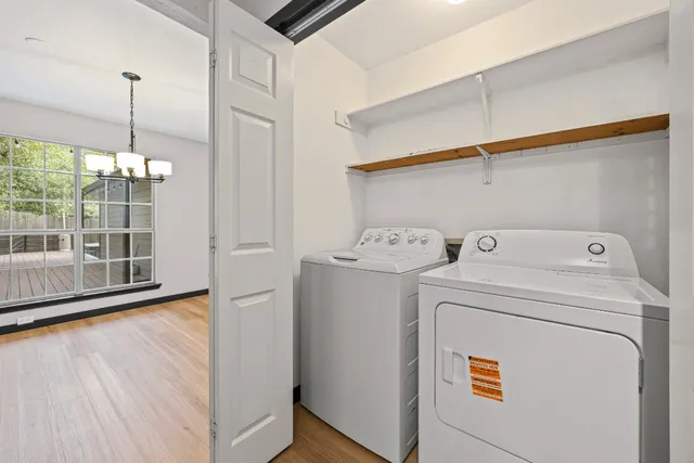 a view of washer and dryer with wooden floor