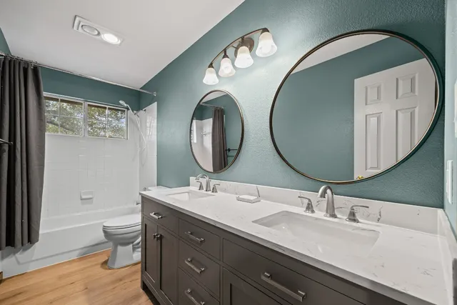 a bathroom with a double vanity sink and a mirror