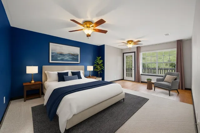 a spacious bedroom with a large bed and a chandelier