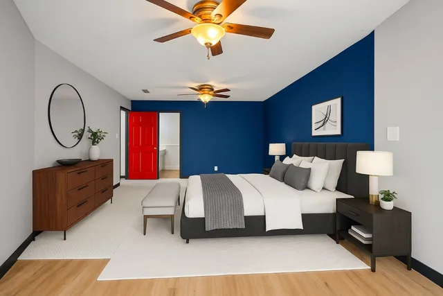 a bedroom with a large bed and a chandelier