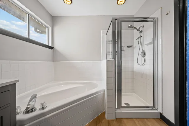 a bathroom with a bathtub and a shower