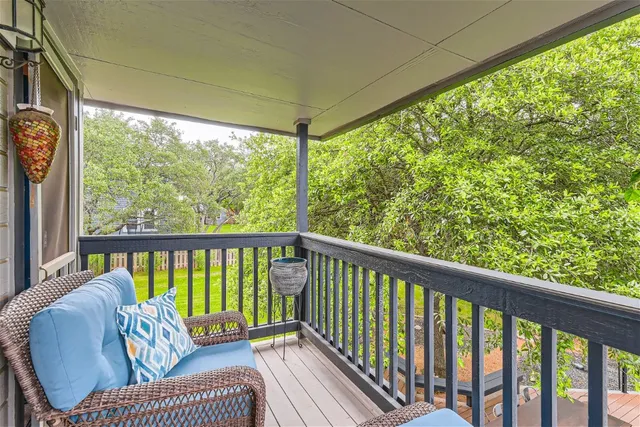 a balcony with furniture and wooden floor