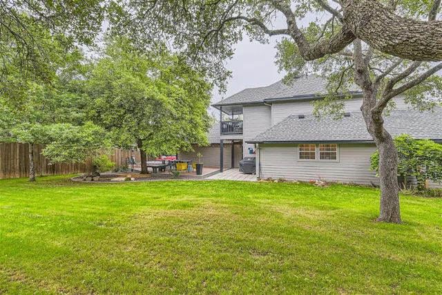 a front view of a house with a yard and trees