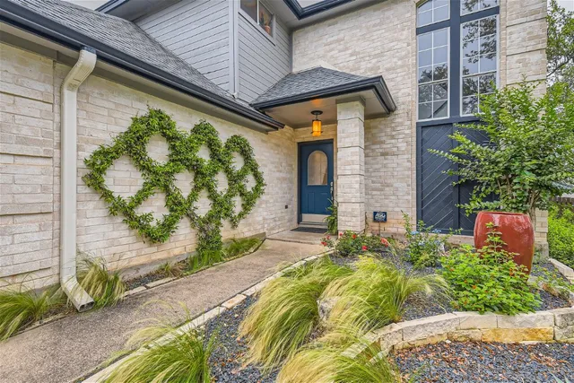 a front view of a house with garden