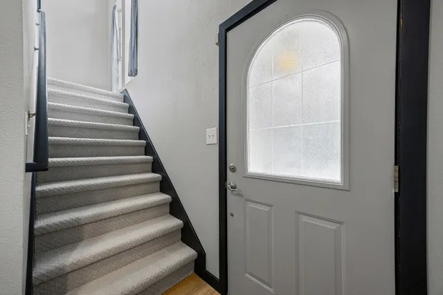a view of staircase with wooden floor and a window