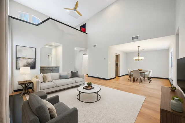 a living room with furniture and a chandelier